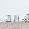 Beach chairs coastal canvas art print by Straatsma Leah showing colorful chairs on a sandy beach scene