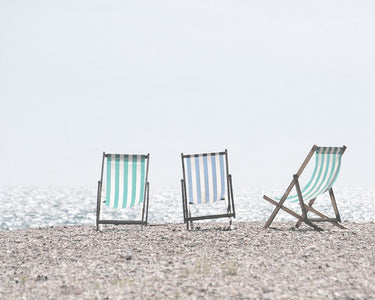 Beach chairs coastal canvas art print by Straatsma Leah showing colorful chairs on a sandy beach scene