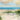 Coastal canvas art print titled "Catching The Wind" by Swatland Sally, featuring a serene seaside scene with gentle waves and wind-blown elements.