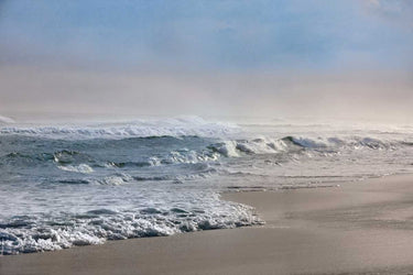 Coastal canvas art print by Jones Mike, depicting a calm sea scene with stormy skies, part of the Feeling at Home collection.