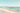 Feeling at home Sunlit Shoreline II coastal canvas art print by Lazar Studio showing a serene beach scene with soft sunlight and shoreline details.