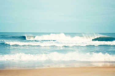 Coastal canvas art print featuring salty sea air scene by Feeling at Home, showcasing ocean waves and beach scenery.