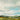 Countryside landscape canvas art print by Feeling at Home featuring a peaceful rural scene with rolling hills and greenery.