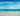 Coastal canvas art print of crashing waves by DeRice Julie, featuring vibrant ocean scenery in a Feeling at Home design.
