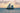Coastal sailing canvas art print by Feeling at Home featuring a serene seaside scene with boats and calm waters.