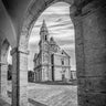 European canvas art print titled "View Through The Arch" by Marie Erin, featuring a scenic landscape view through an arch.
