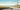 Coastal canvas art print of a lighthouse by the sea, created by Wiens James for Feeling at Home, showcasing a serene seaside scene.