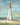 Lighthouse III coastal canvas art print by Nai Danhui, featuring a serene seaside lighthouse scene in warm tones.