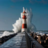 Mediterranean lighthouse coastal canvas art print by Feeling at Home, showcasing a serene seaside scene with a lighthouse and calm waters.
