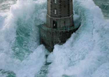 Coastal canvas art print titled "Phares Dans La Tempête La Jument" by Guichard Jean, depicting a lighthouse in stormy seas.