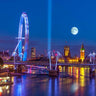 Night view of London's Thames River with the London Eye, Golden Jubilee Bridge, and Westminster in a canvas art print by Feeling at Home.