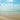 Coastal canvas art print by Frank Assaf depicting a beautiful beach with cloudscape, suitable for home decor from Feeling at Home.