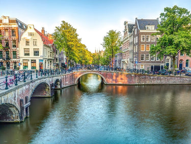 Amsterdam canal cityscape photography canvas art print by Frank Assaf, featuring a picturesque canal scene in vibrant colors.