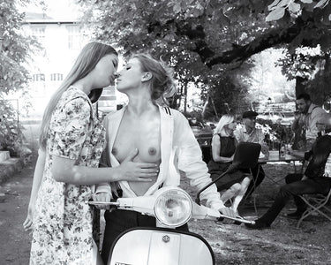 Unconventional kiss in Vespa photography canvas art print by Skellern Sue, featuring a romantic scene with a Vespa scooter.