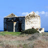 Silent ruined ancient house front sea landscape canvas art print by Giordano V., featuring a weathered house overlooking the ocean.