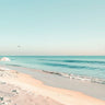Feeling at home Sunlit Shoreline II coastal canvas art print by Lazar Studio showing a serene beach scene with soft sunlight and shoreline details.