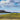 Blue skies landscape canvas art print by Feeling at Home featuring a vibrant blue sky and scenic natural view.