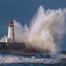 Coastal canvas art print of a lighthouse in a raging sea by Feeling at Home, showcasing a dramatic maritime scene.