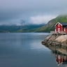 Coastal canvas art print of fishing huts on Lofoten waterfront, Norway, by Feeling at Home, featuring scenic seaside village views.