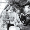 Unconventional kiss in Vespa photography canvas art print by Skellern Sue, featuring a romantic scene with a Vespa scooter.