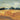 Gold glitter countryside landscape art print by Berge Thomas Tepstad, featuring a scenic rural scene on a canvas from Feeling at Home.