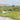 Landscape canvas art print titled The Stream by Zucca Gianfranco, featuring natural scenery with flowing water and lush greenery.